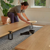 got to pdp-hero | Bed Panels in Oak. || A man assembles the floyd bed.