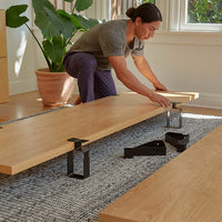 got to pdp-mobile-hero | Bed Panels in Oak. || A man assembles the floyd bed.